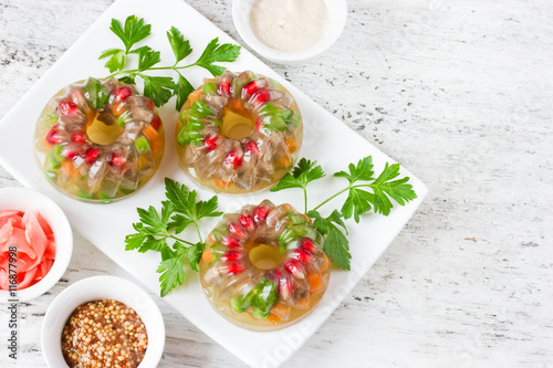 Beef aspic with pomegranate, green peas, carrot and parsley