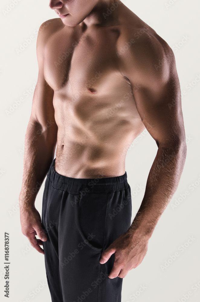 Fototapeta premium Healthy muscular young man posing. Sport portrait. Detail.