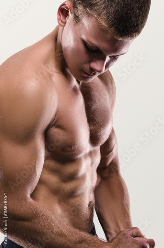 Healthy muscular young man posing. Sport portrait.