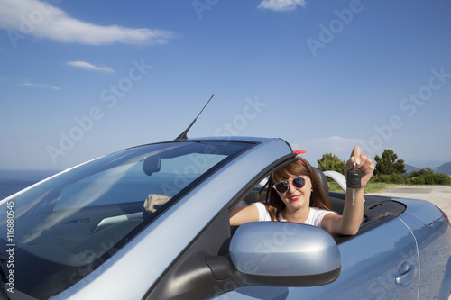Young woman drive a car on the beach. © ballabeyla