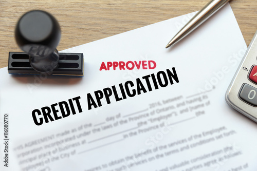 Canvas Print Approved credit application form lay down on wooden desk