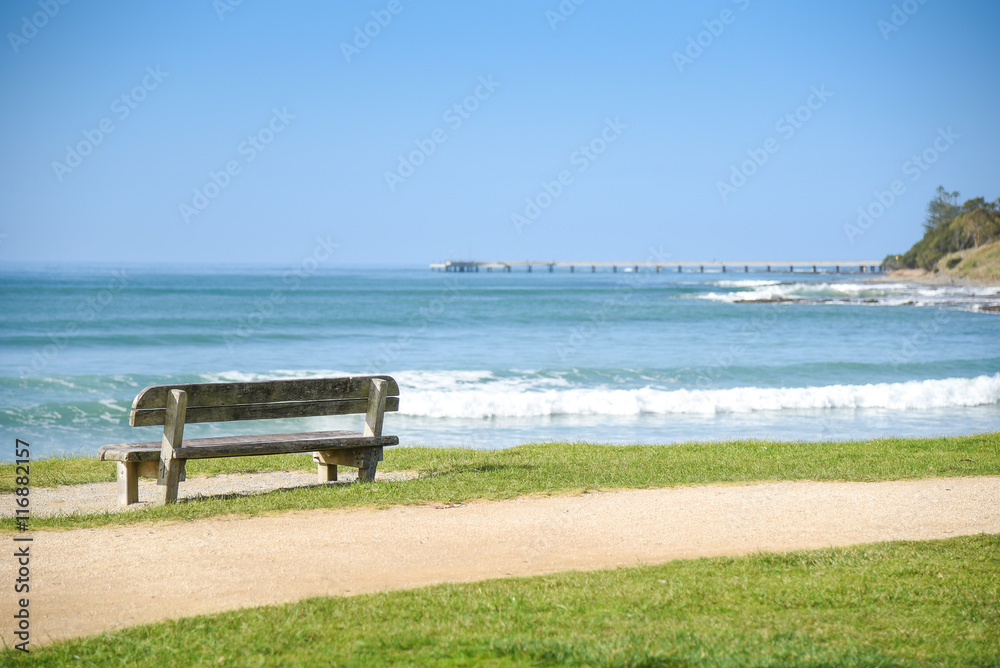 Wood bench near beach and sea