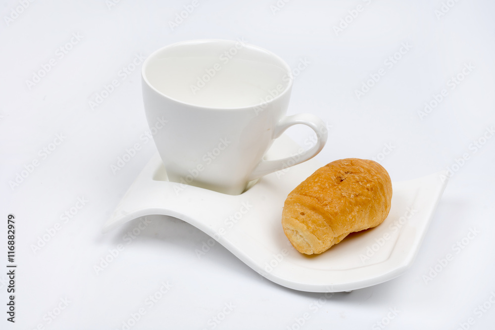 White cup for coffee with croissant over white background White cup for coffee with croissant over white background