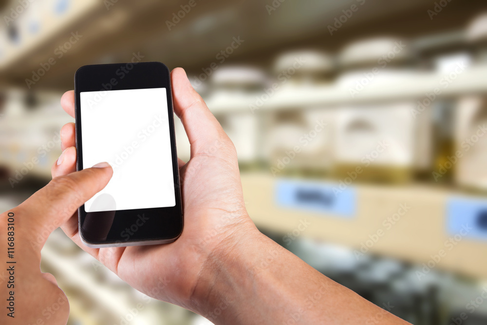 Person using smartphone white screen holder on hand with blurry Person using smartphone white screen holder on hand with blurry