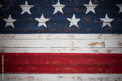 United States flag painted on wooden planks forming a background