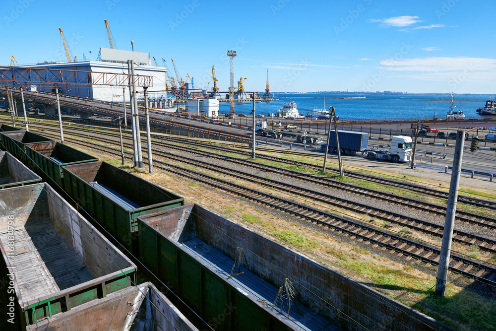 infrastructure of industrial cargo seaport with railroad car, truck and ship, road over the bridge