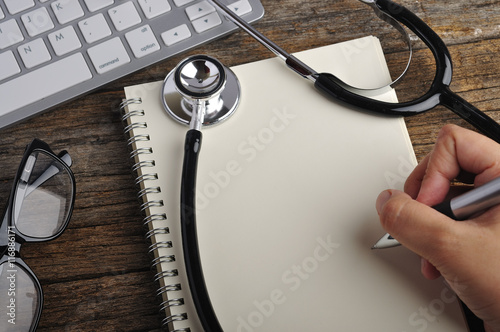 Top View of Doctor Office with Stethoscope and Notebook and Comp