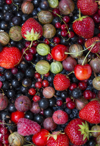 berry background with fresh raspberries, blueberries, currants, strawberries, cherries