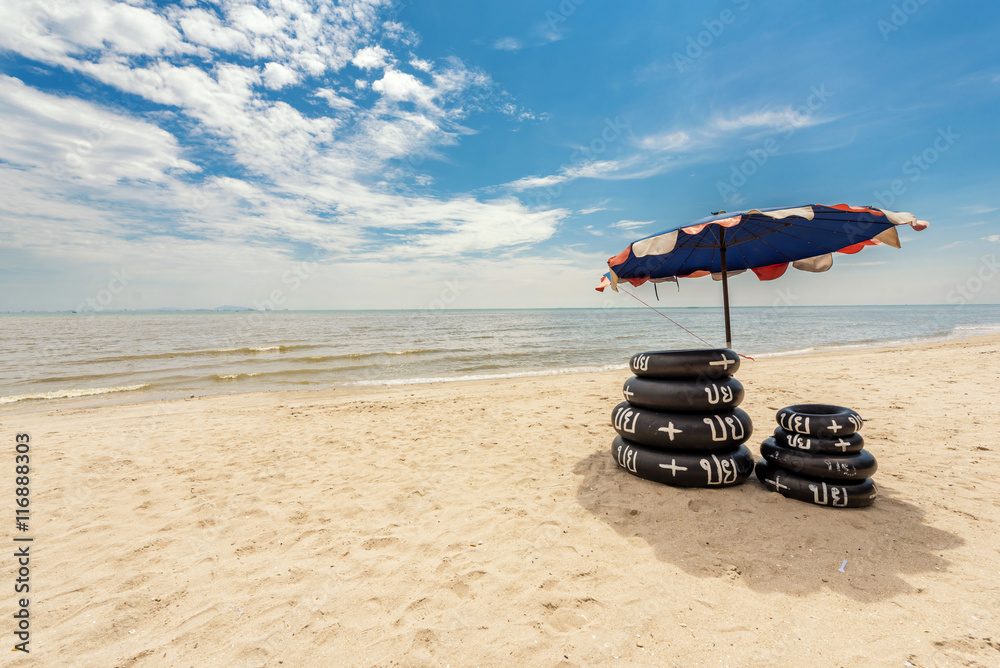 Local swim ring with umbrella on the beach in Thailand