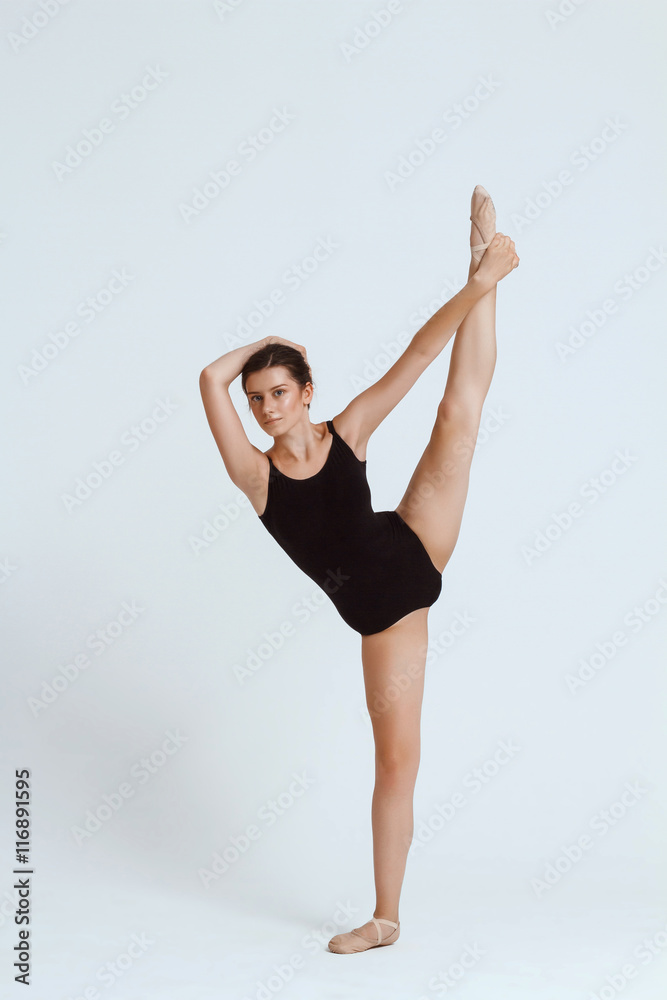 Young beautiful contemporary dancer posing over white background. Copy space. Young beautiful contemporary dancer posing over white background. Copy space.