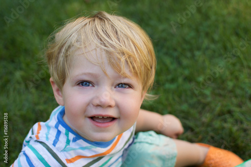 young toddler boy smiling outdoors © hollydc
