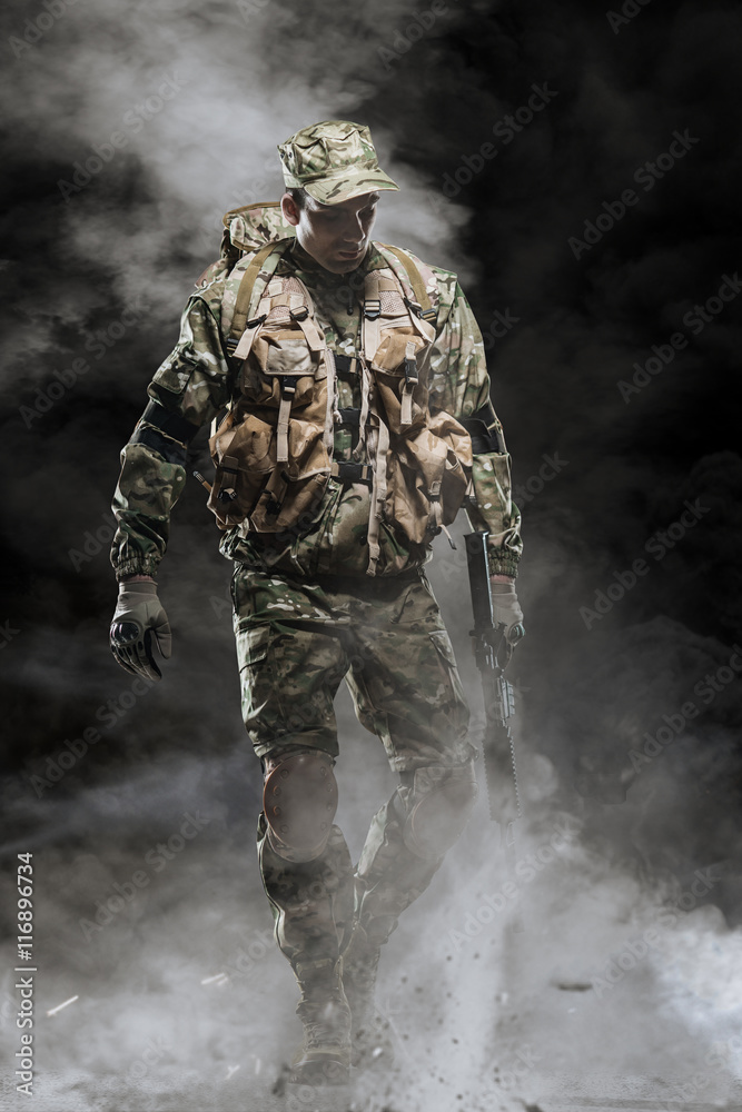 Special forces soldier man hold Machine gun on a dark background Special forces soldier man hold Machine gun on a dark background