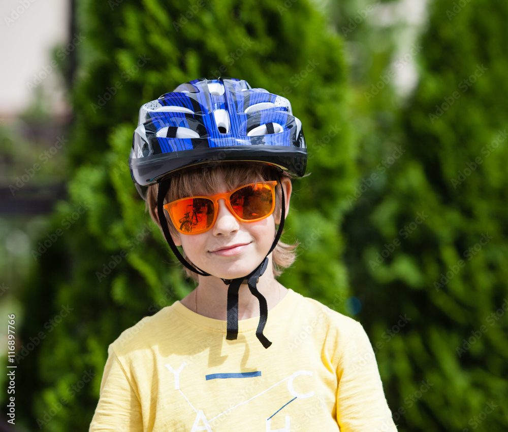Cute boy with orange sunglasses and protective helmet
Cute boy with orange sunglasses and protective helmet