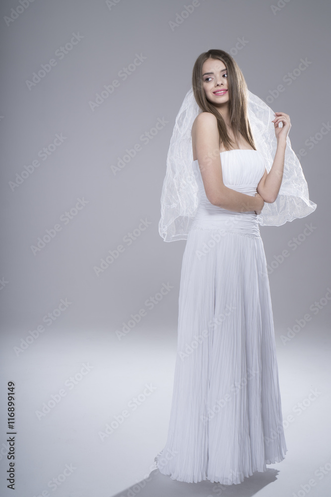 Happy sexy beautiful bride brunette girl in white wedding dress on white background Happy sexy beautiful bride brunette girl in white wedding dress on white background