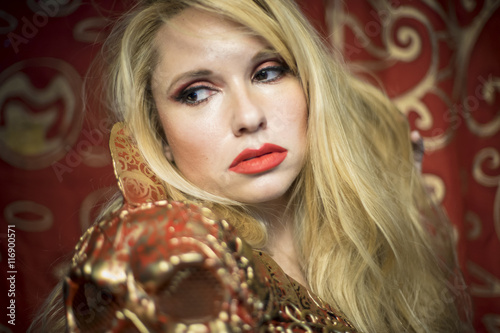 Sweet, blonde dressed in red armor gold on red art nouveau flour