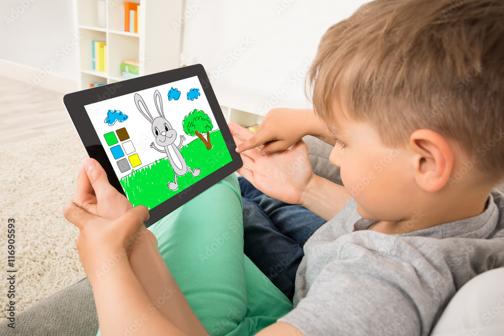 Boy Playing Game On Digital Tablet Boy Playing Game On Digital Tablet