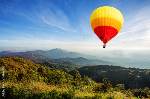 Colorful hot air balloon over mountain © littlestocker