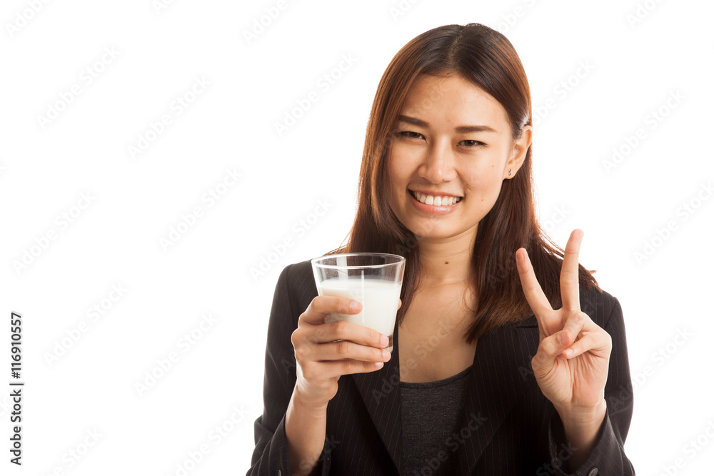 Healthy Asian woman drinking a glass of milk show victory sign. Healthy Asian woman drinking a glass of milk show victory sign.