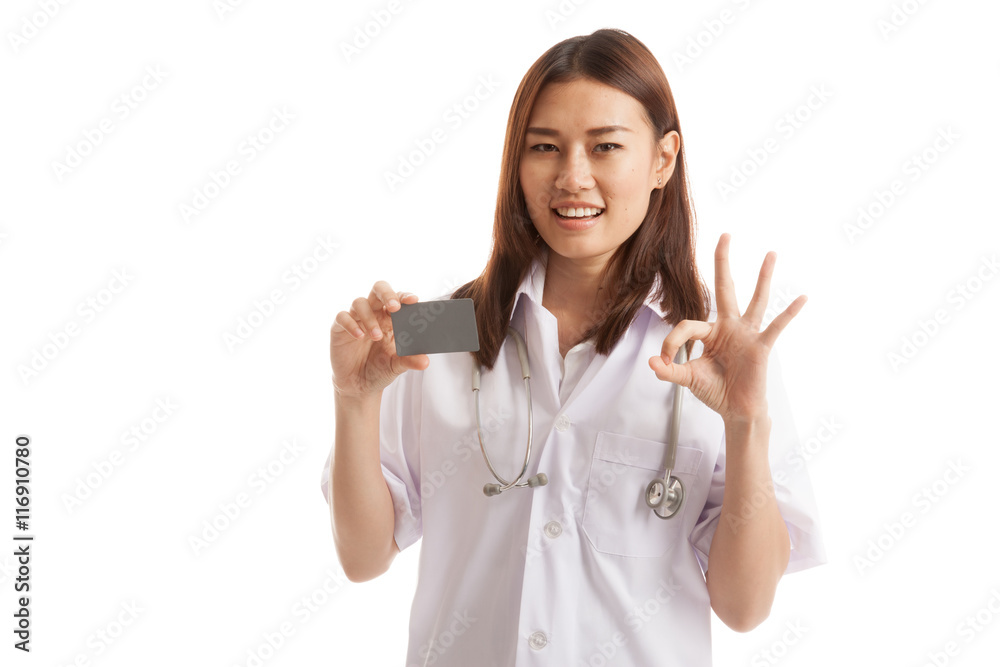 Asian young female doctor show Ok sign with blank card. Asian young female doctor show Ok sign with blank card.