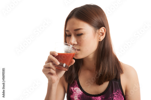 Beautiful healthy Asian girl drink tomato juice.