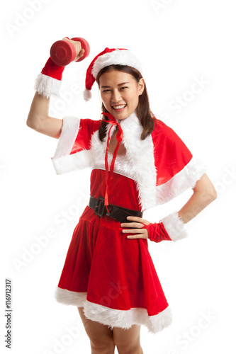 Asian Christmas girl with Santa Claus clothes and red dumbbell.