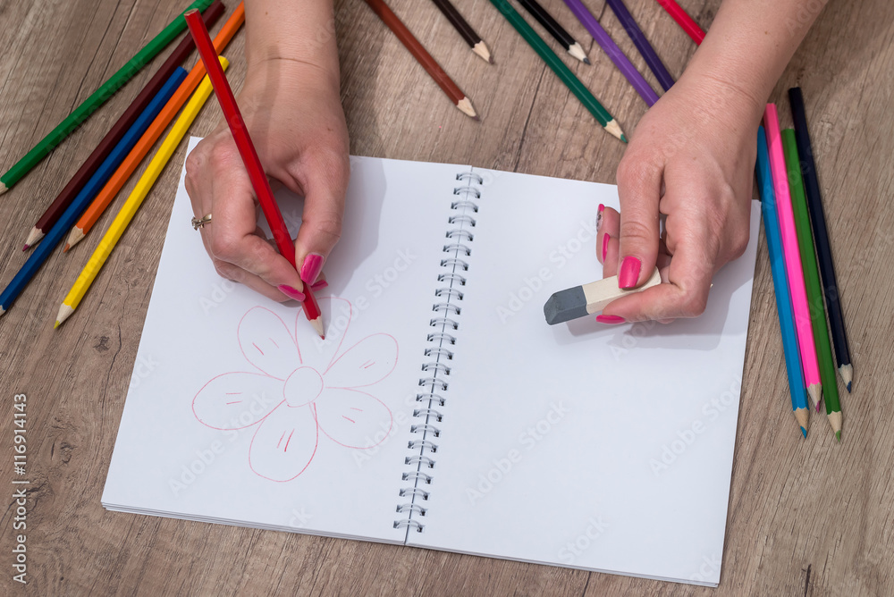 she draws with colored pencils on notebook she draws with colored pencils on notebook