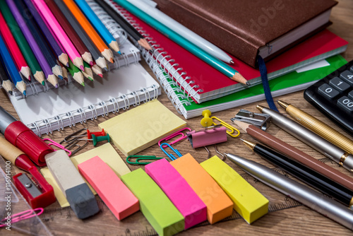 different school supplies on a wooden table photo