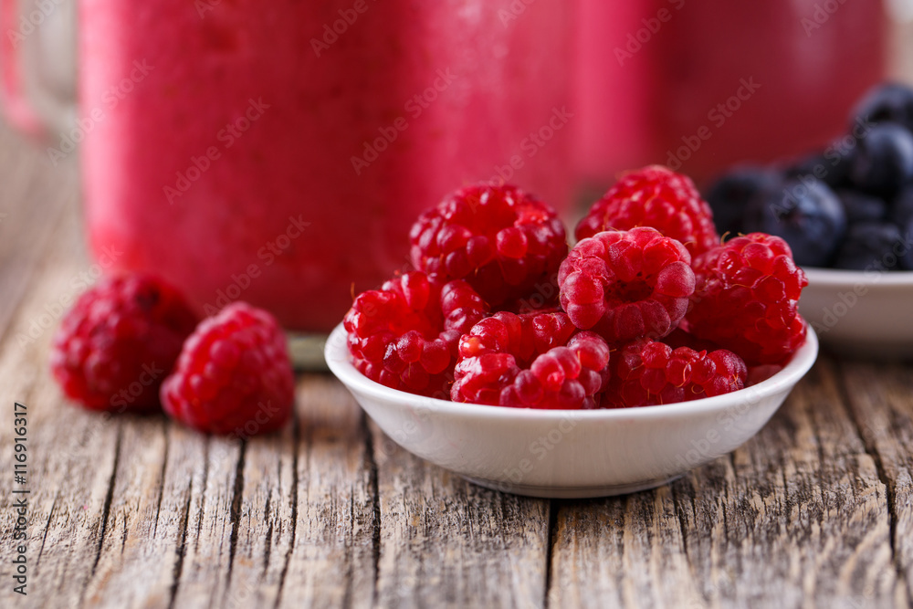 Plates with berries and smoothie background. Plates with berries and smoothie background.