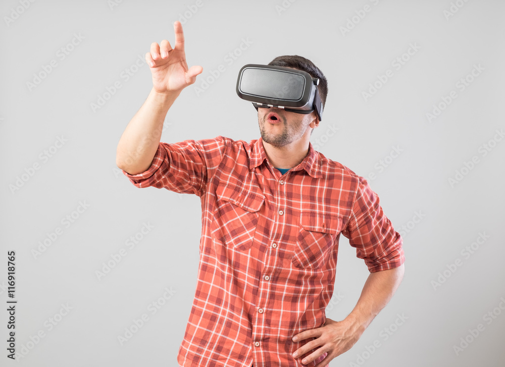 Man with virtual reality glasses showing gesture Man with virtual reality glasses showing gesture