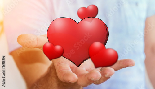 Young man holding hand drawn red heart