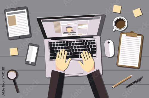 hands typing text on the laptop keyboard and using social networks for communication. Top view of people working with computer at the work desk vector