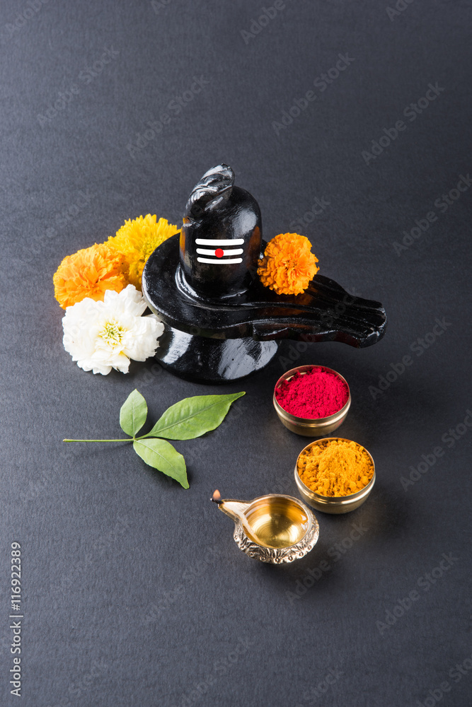 Shiva Linga made up of black stone decorated with flowers & bael leaf known as Aegle Shiva Linga made up of black stone decorated with flowers & bael leaf known as Aegle