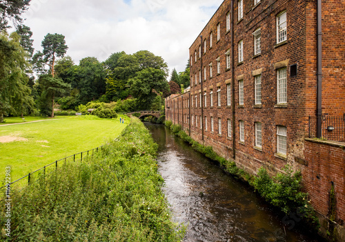 Styal, Cheshire, UK. July 26th 2016. Quarry Bank Mill in countryside setting on cloudy summer day, Styal, Cheshire, UK