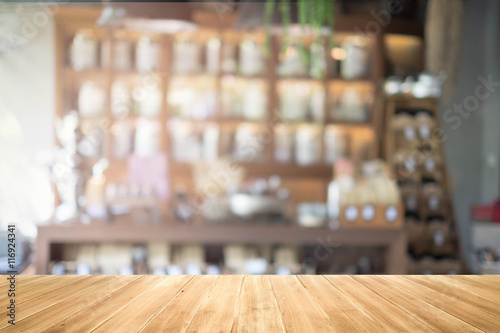 Empty wood table and blurred coffee shop background. product display