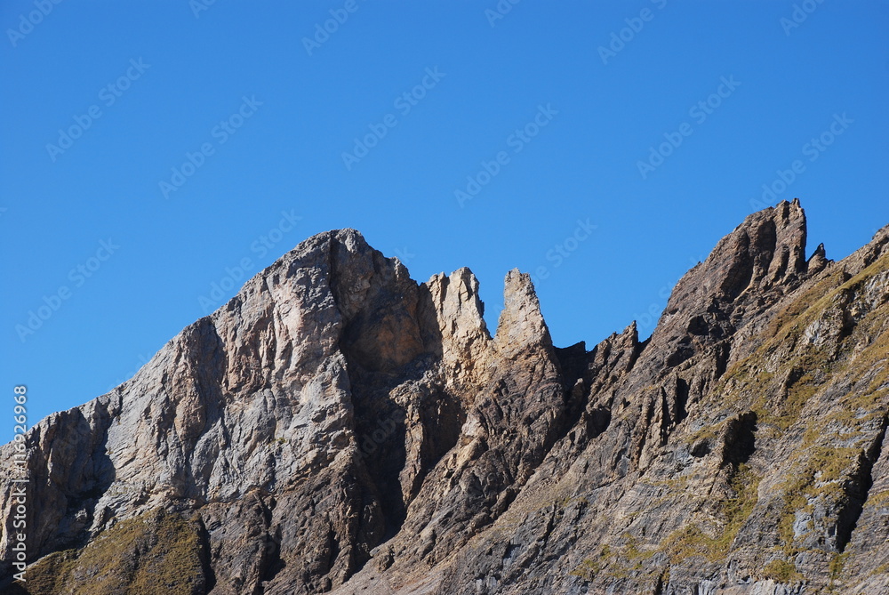 Rock cliff blue sky Swiss alps