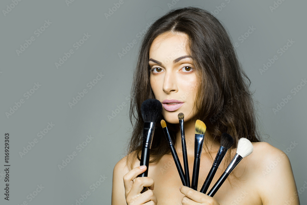 pretty woman with makeup brush