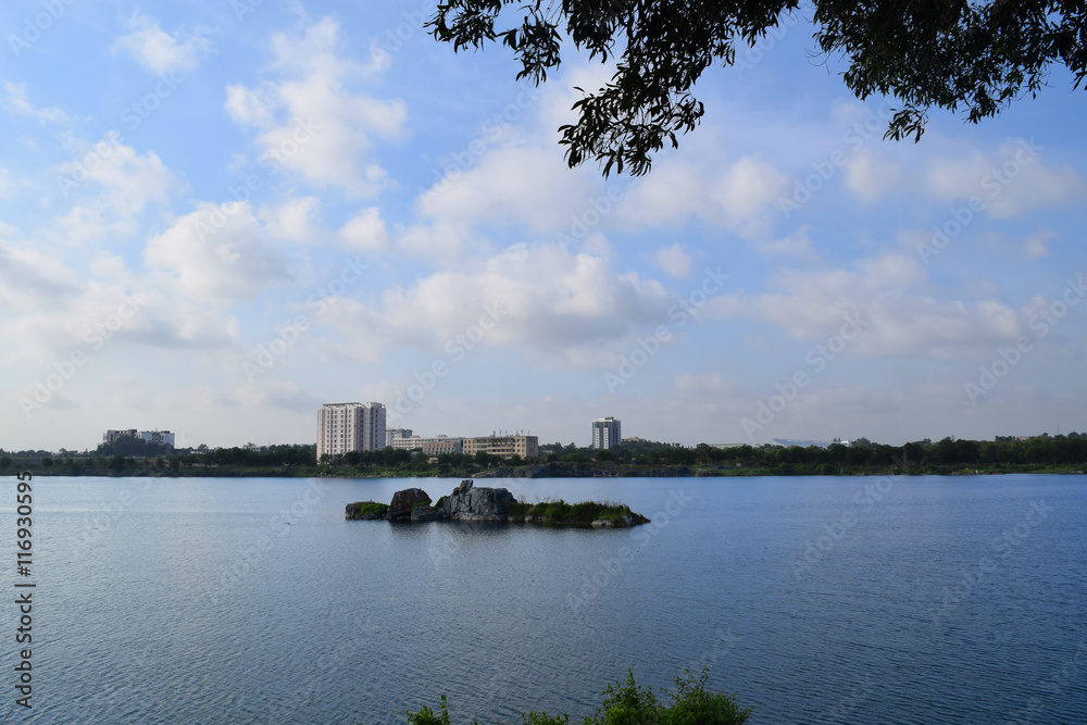 rocky lake with building in the bank