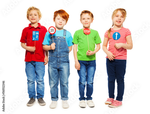 Fotografia Four happy kids studying safety of traffic rules