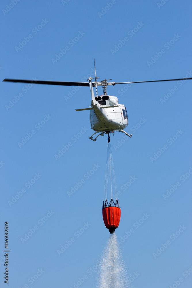 Helicopter fire fighting with a bambi bucket Helicopter fire fighting with a bambi bucket