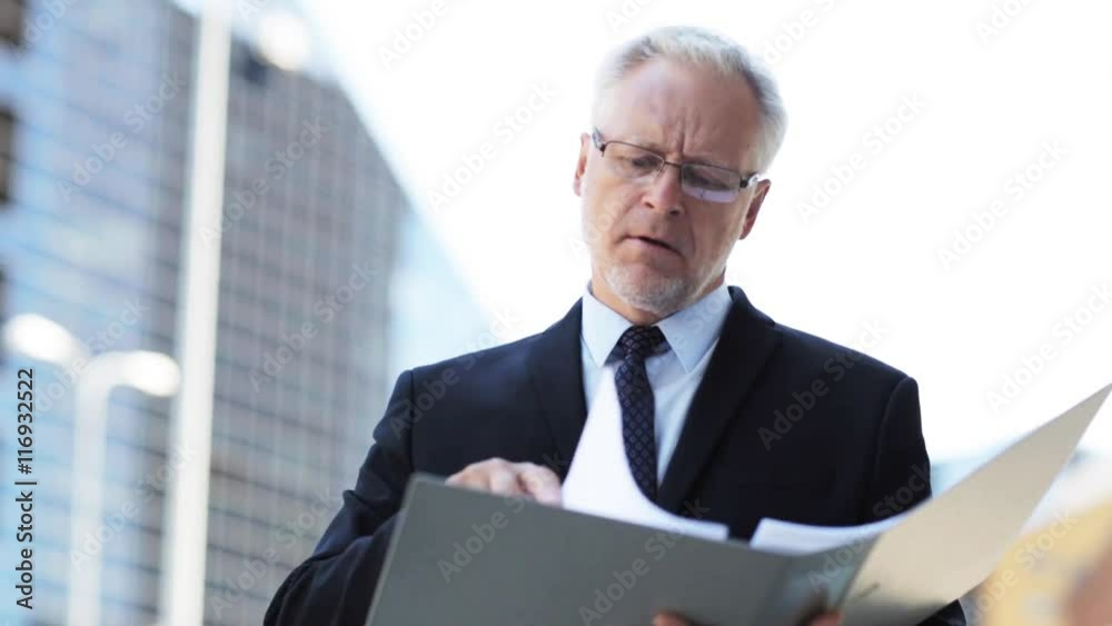 senior businessman with ring binder folder in city senior businessman with ring binder folder in city