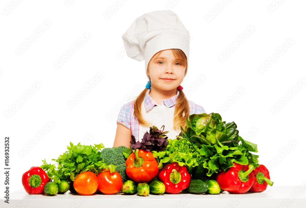 Young cook in uniform with fresh vegetables Young cook in uniform with fresh vegetables
