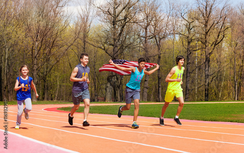 Four young sprinters waving American flag on track © Sergey Novikov