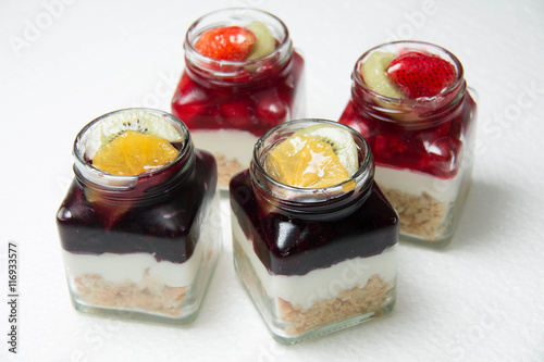  Dessert with blueberries and cherry in glass bottle