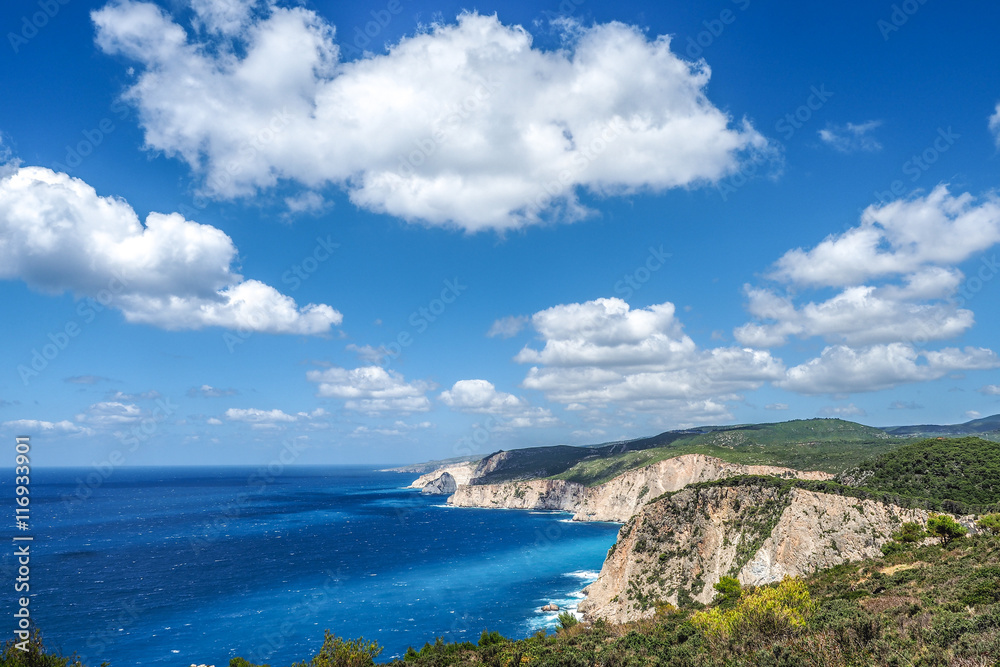 Zakynthos cliff panorama with clear water, blue sky and white cl