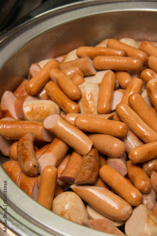  Cutting german sausage and meat in dish