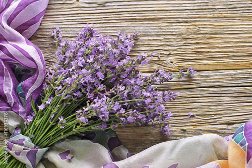 Fototapeta Naklejka Na Ścianę i Meble -  bouquet of lavender with  silk  scarf on wooden table 