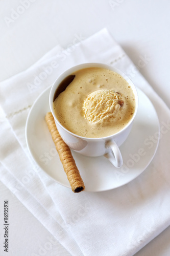Black coffee with ice cream and chocolate stick