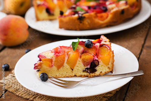 Delicate biscuit pie with peaches and blueberries.
