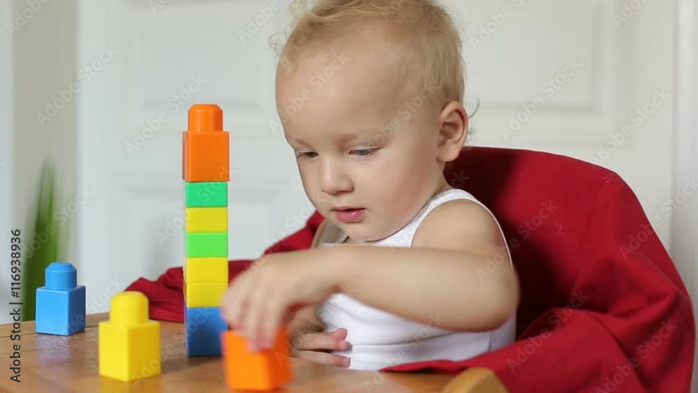 Little cute toddler playing with color blocks Little cute toddler playing with color blocks