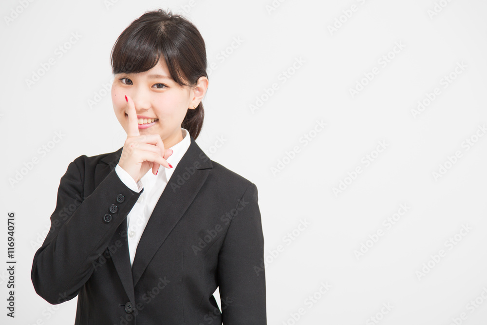 内緒のポーズをするスーツの女性 Stock 写真 Adobe Stock